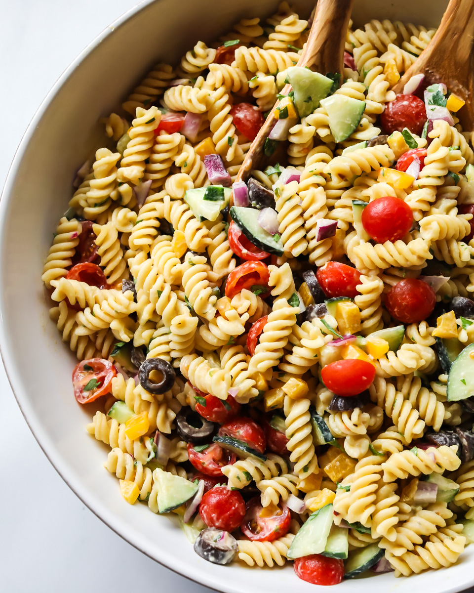 Hummus pasta salad in a white bowl.