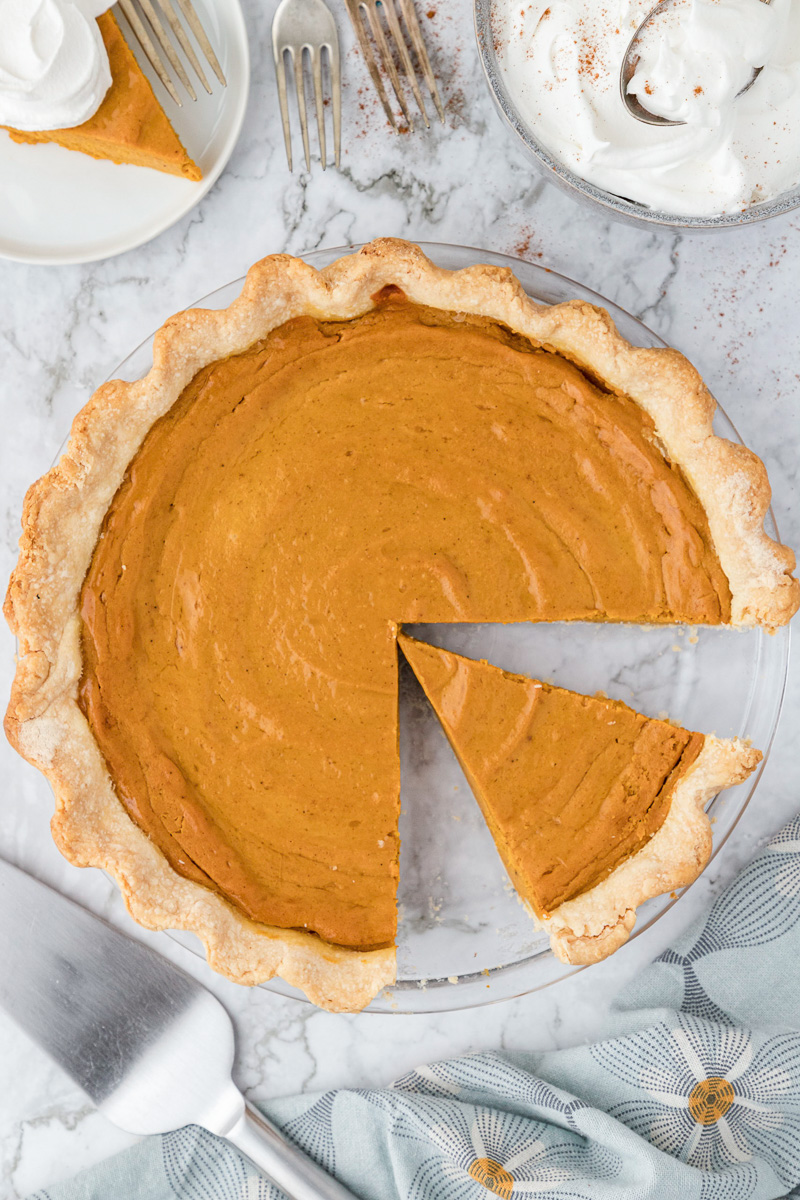 Sweet potato pie with slice cut out.