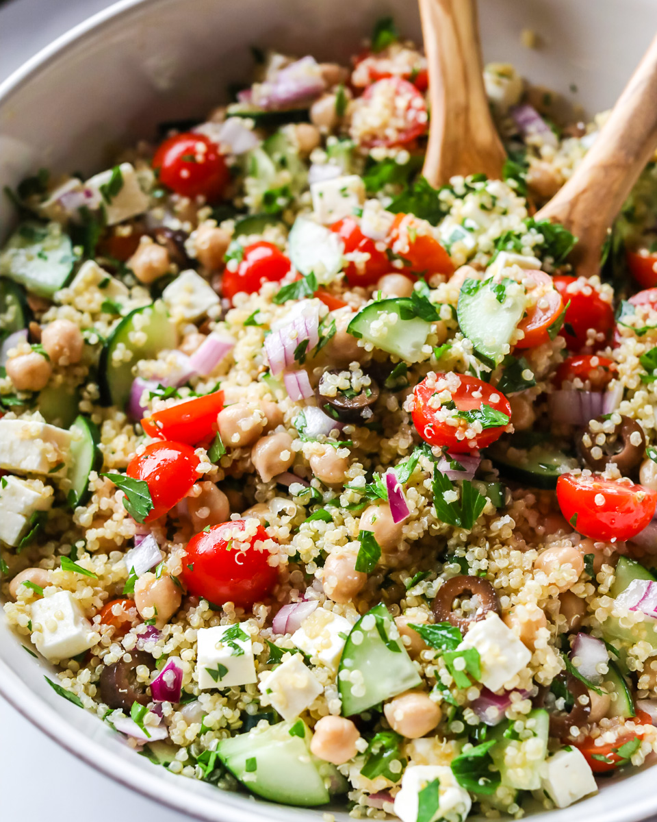 Mediterranean quinoa salad in white bowl.