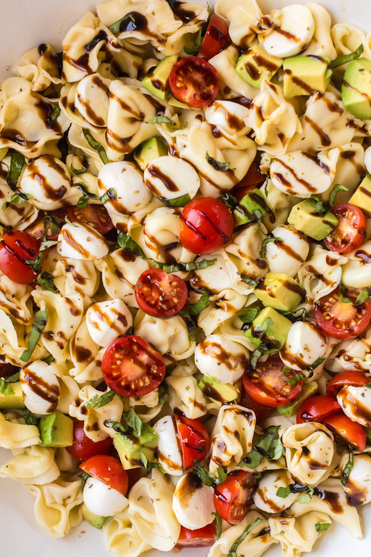 Tortellini caprese salad with balsamic glaze.
