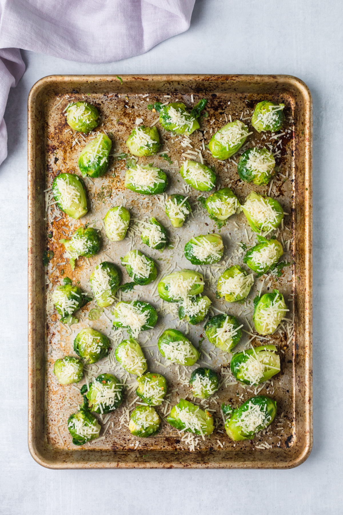 Brussels sprouts on baking sheet with parmesan. 