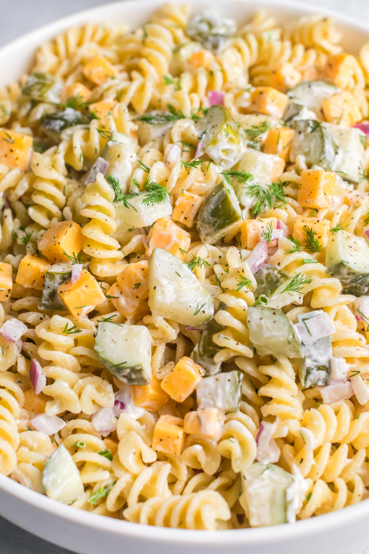 Creamy dill pickle pasta salad in bowl. 